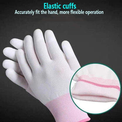 White gloves with pink elastic cuffs on a dark background