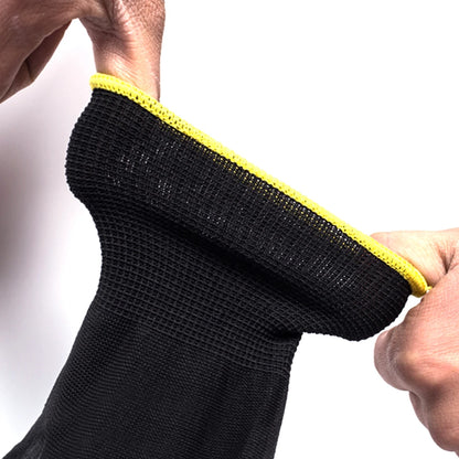 Black sock with yellow trim held by a hand against a white background